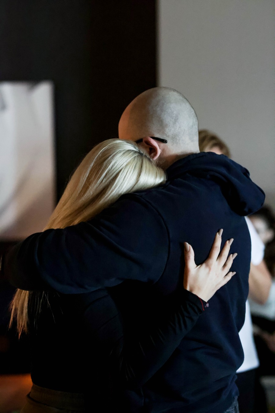 Two participants holding each other after a shared exercise