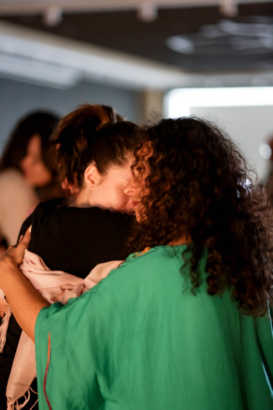 Two participants leaning into a long embrace