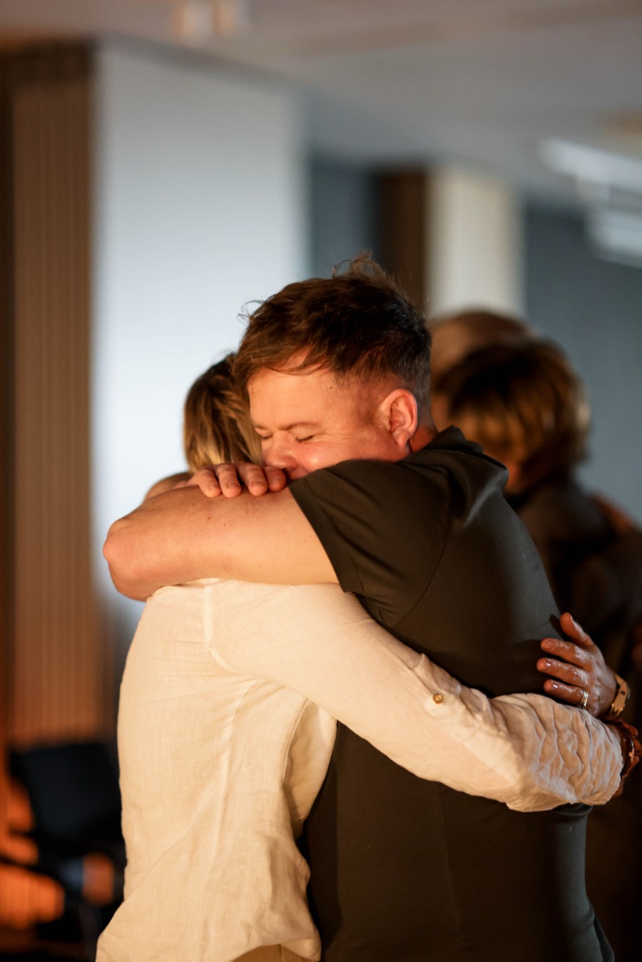 Two participants holding each other with their eyes closed at the end of the day