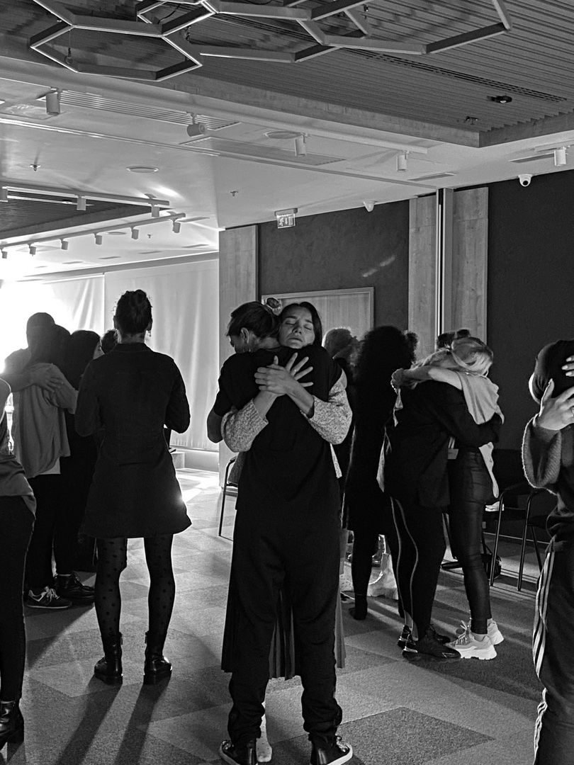 Participants greeting one another in the hall between sessions