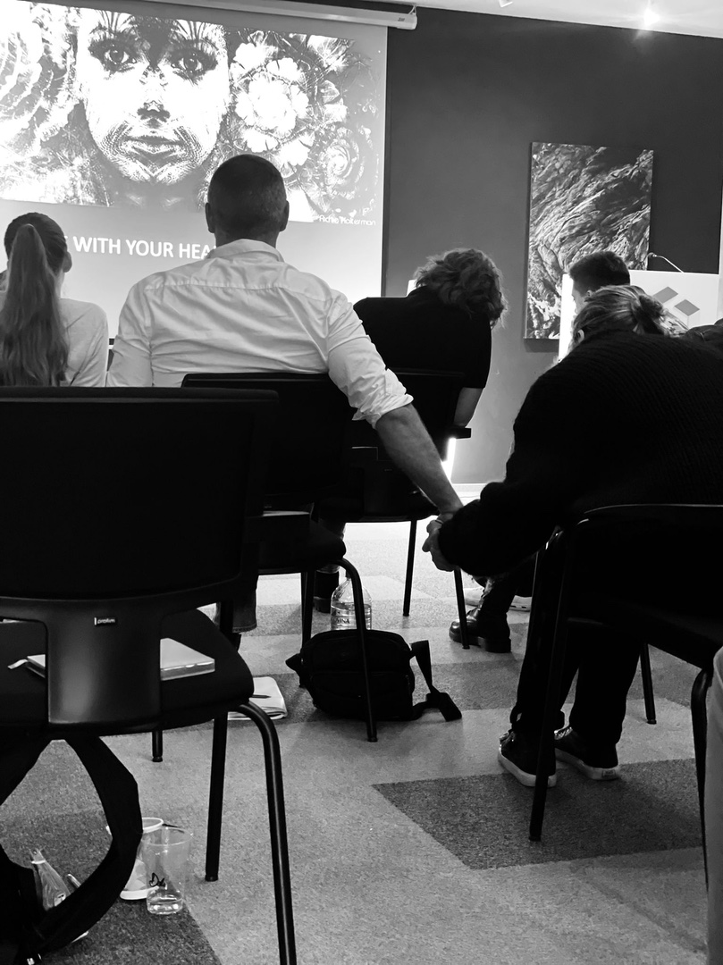 Participants seated in front of the See With Your Heart screen