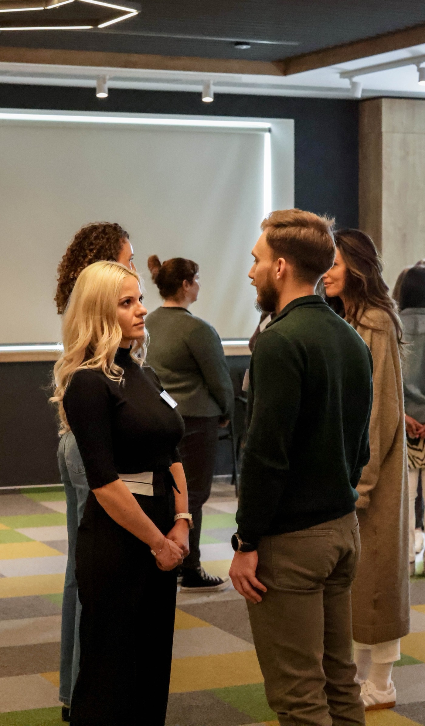 Two participants standing face to face during an exercise in pairs
