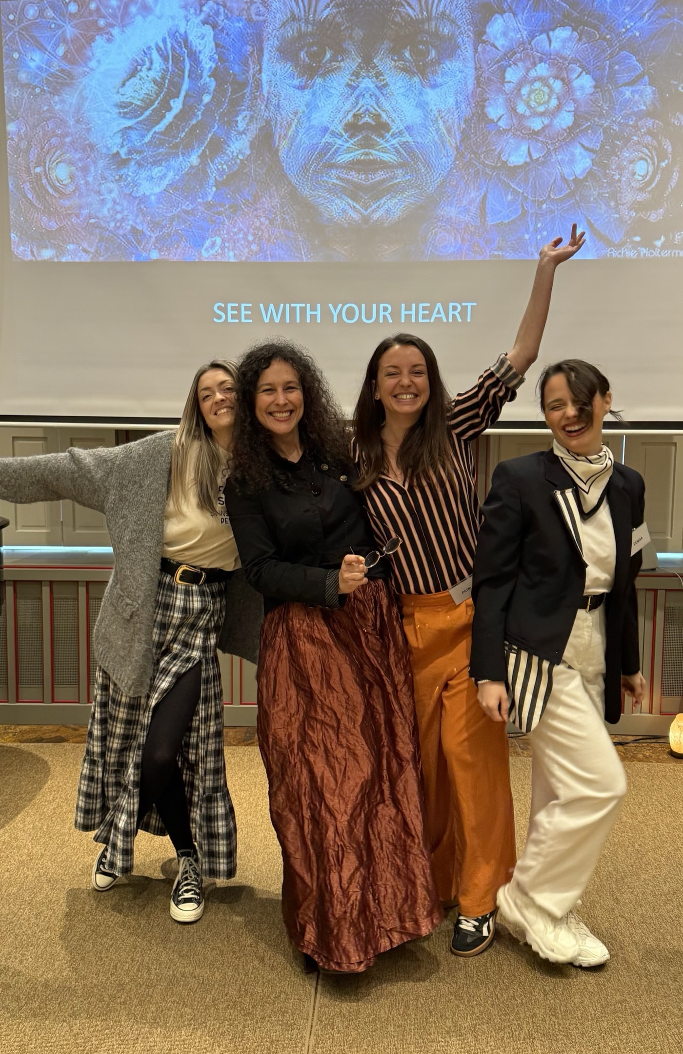 Andrea with workshop participants celebrating under the See With Your Heart banner