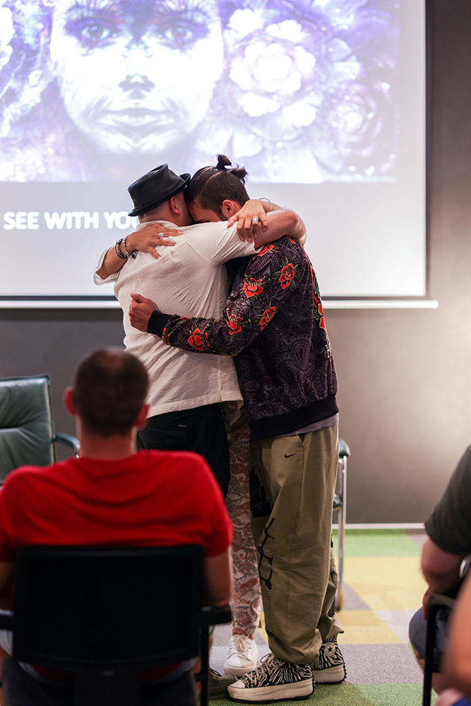 Two participants hugging at the workshop